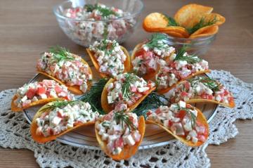 Amuse-gueule salade avec des bâtons de crabe sur des puces pour la nouvelle année